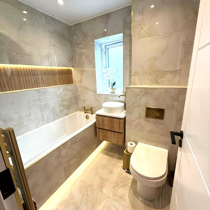 Bathroom designed with Onyx gold marble tile with gloss finish and soft gold veining