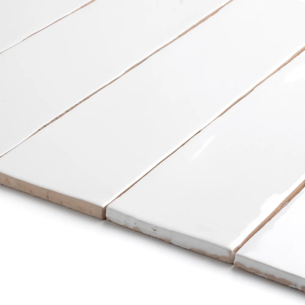 Close-up of Bespoke white rustic gloss ceramic tile with earthy tones and uneven edges