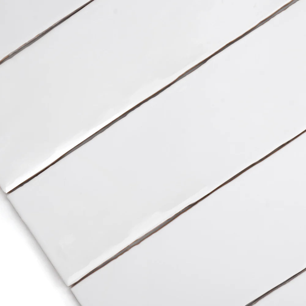 Close-up of bespoke white rustic gloss ceramic tile with uneven edges