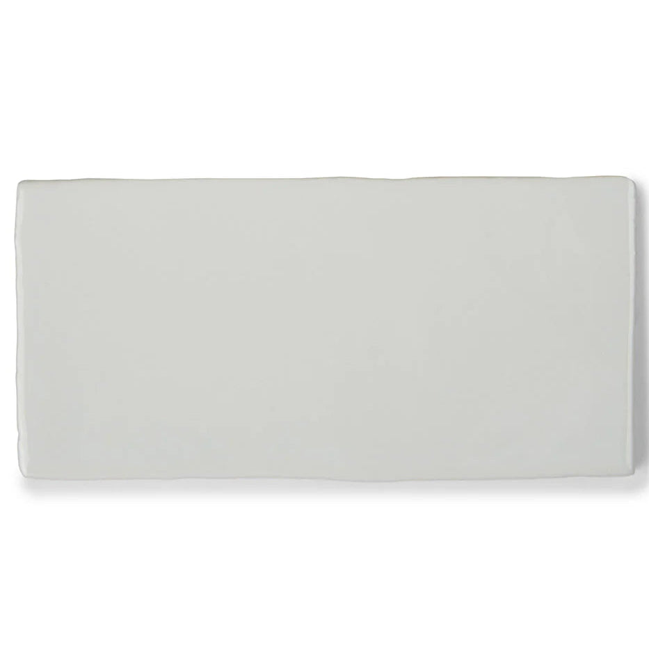 Close-up of bespoke white rustic ceramic wall tile with handmade textured finish