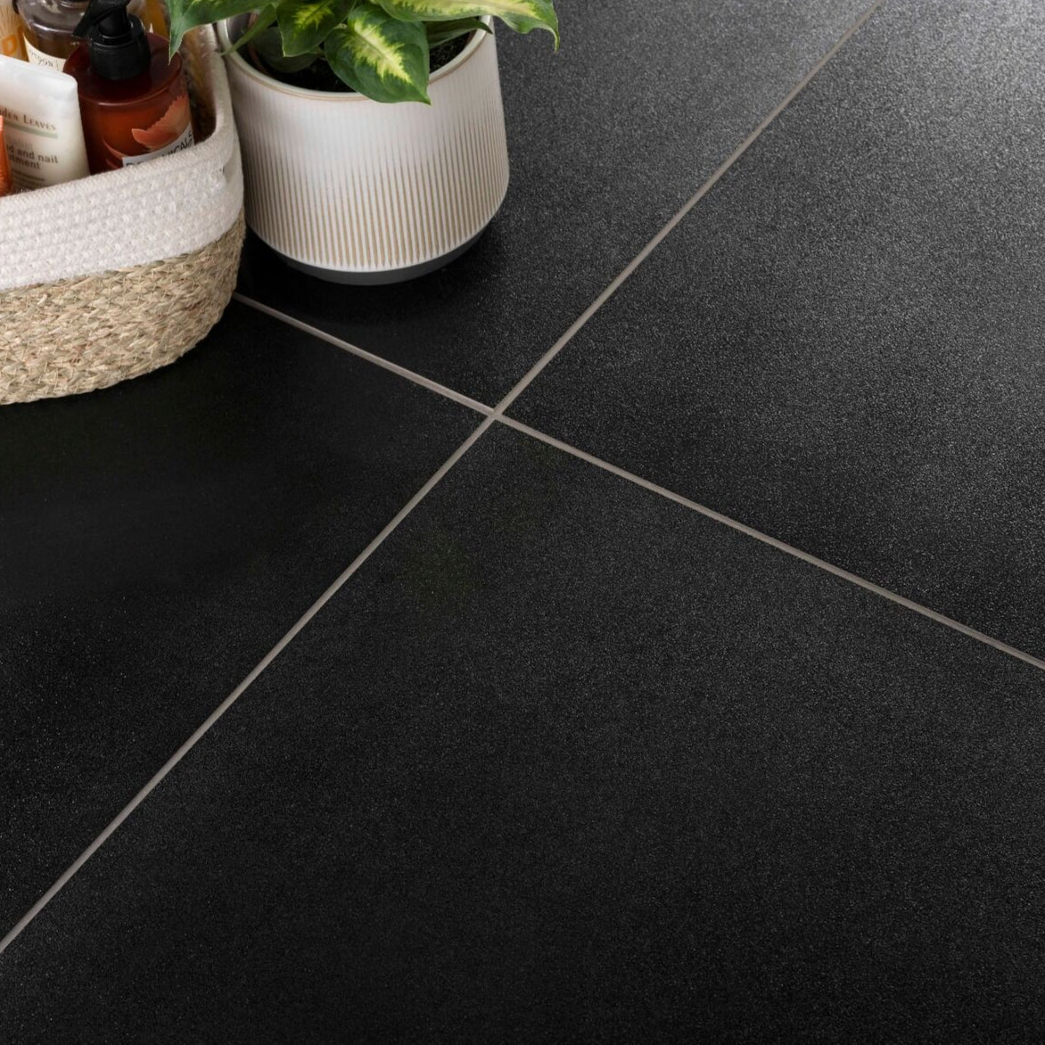 Floor tiled with Sparkle black porcelain wall and floor tile featuring a shimmering sparkle effect